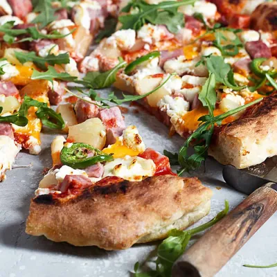 Signature cheese pizza with melty mozzarella at Nose Creek Pizza Coventry Hills Calgary